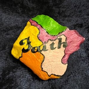 Hand painted rock that says Faith. 3x 2.75 in